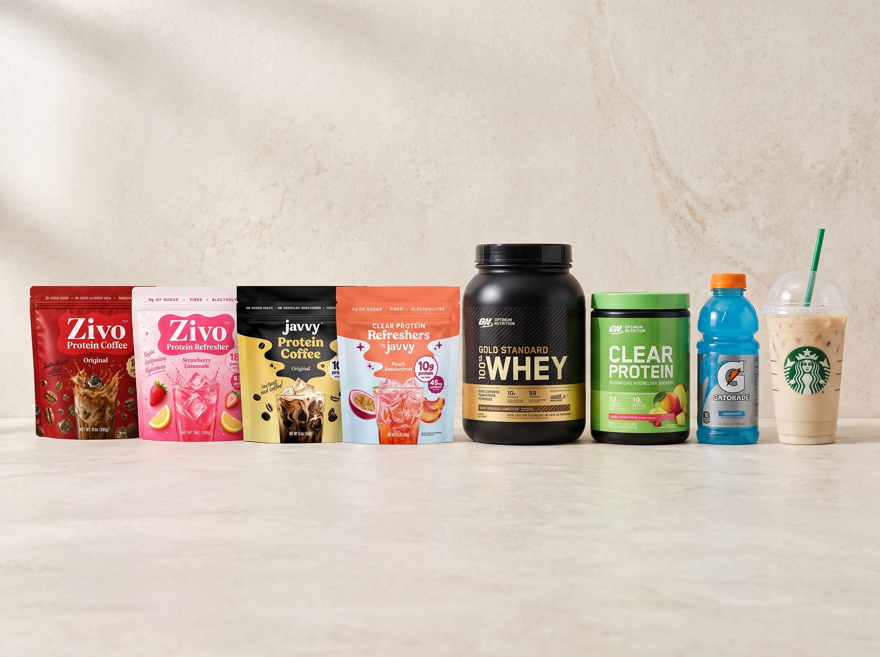 Lineup of protein coffee and refresher products laid out on a kitchen counter for comparison testing